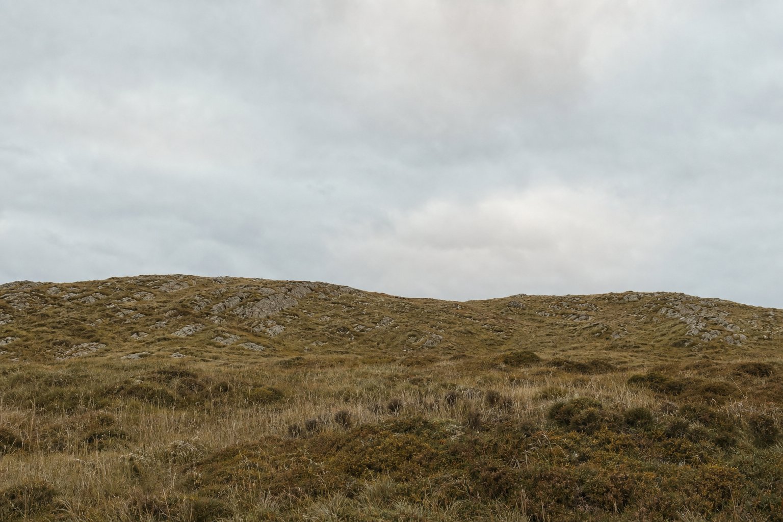A low ridge crossing the frame with the ground behind it hidden from view.